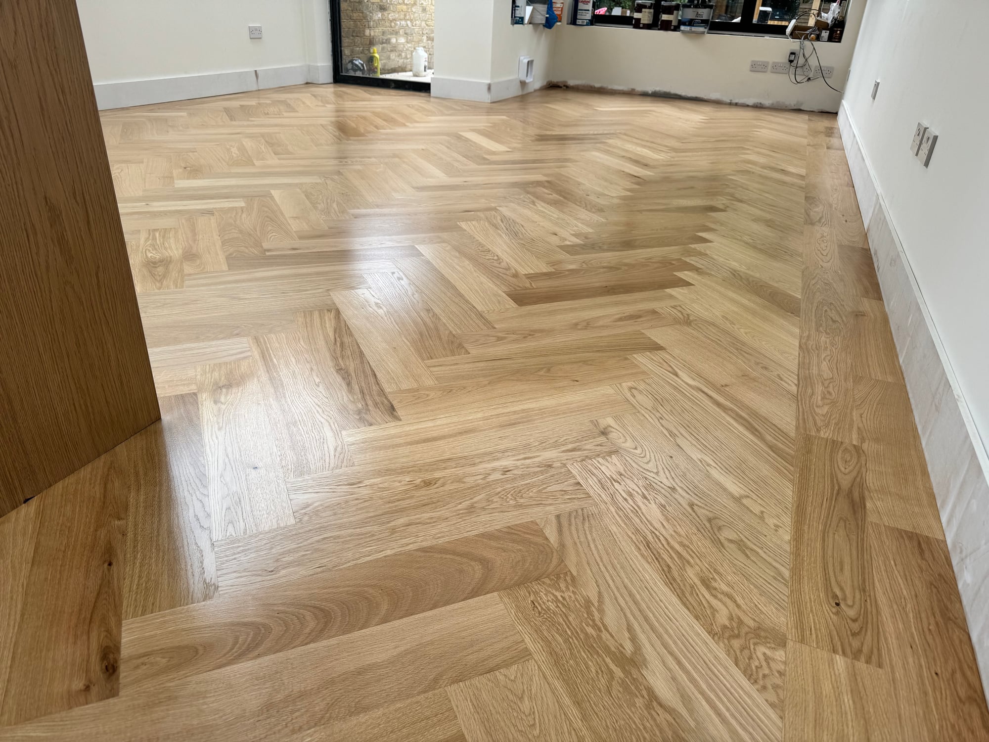 Restored light oak herringbone parquet floor in Wimbledon